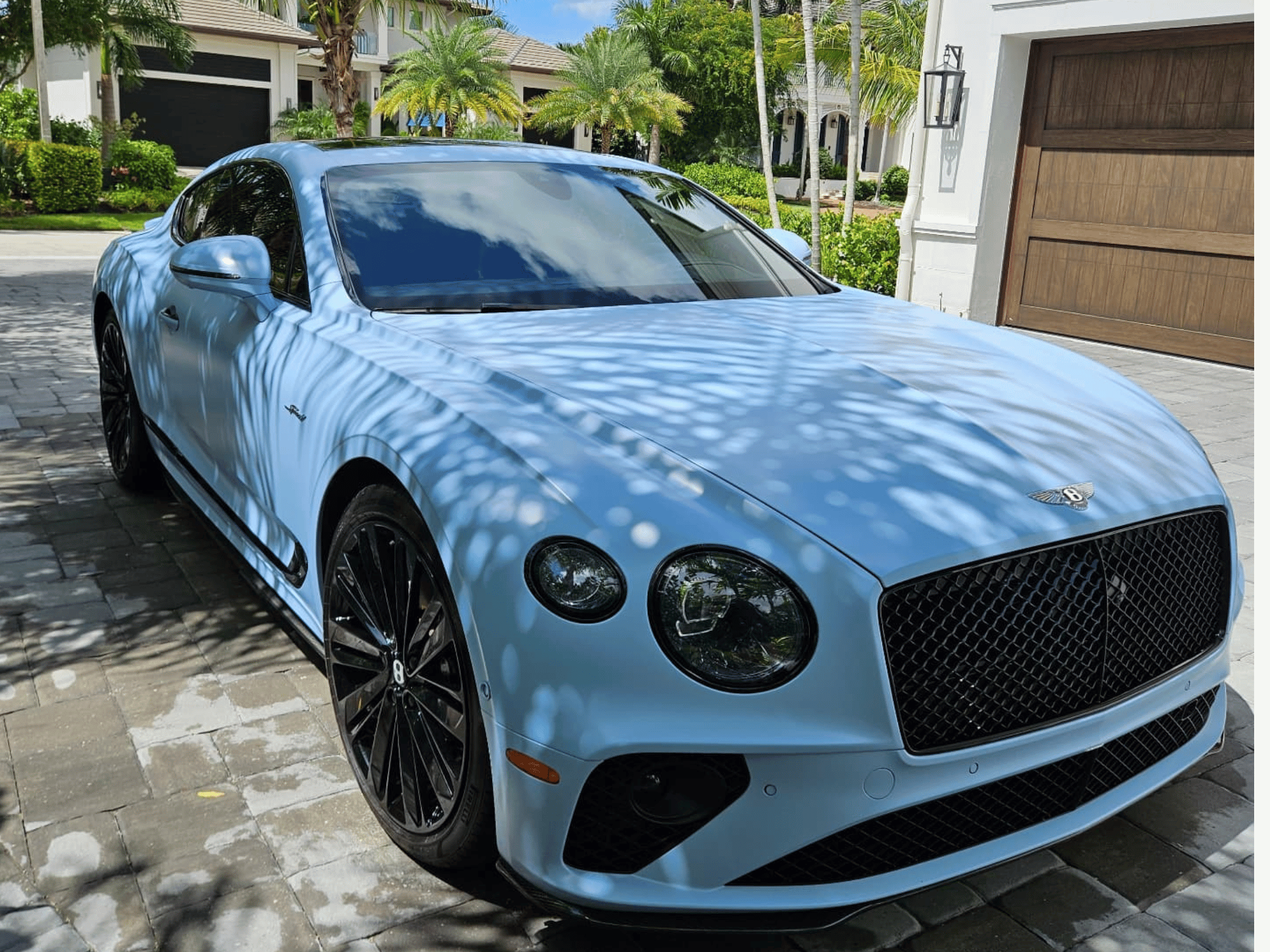 Luxury exterior detail on light blue Bentley coupe in Naples Florida